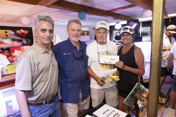 Wendy, Dr. Mascia, Johnny Vetra and Tim smile to camera. 